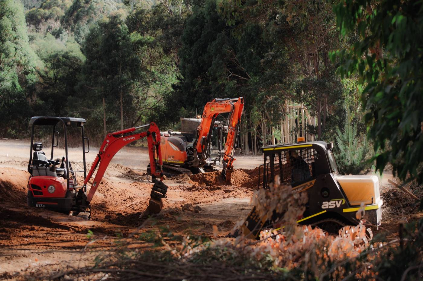 Three machines mid-build at Pine Ridge, Nannup